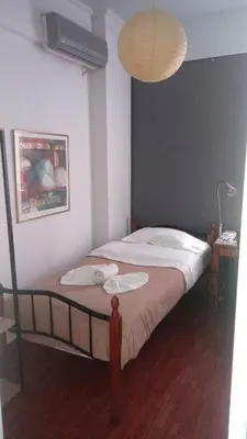 a bedroom with a bed with a fan and a lamp at WineSpa Oasis in Athens ! in Athens