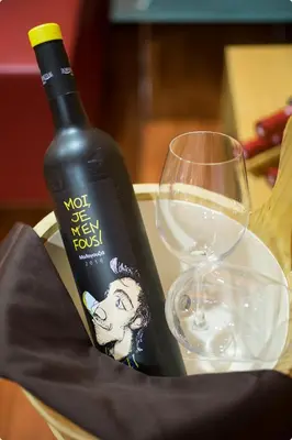 a bottle of wine and two glasses on a table at WineSpa Oasis in Athens ! in Athens