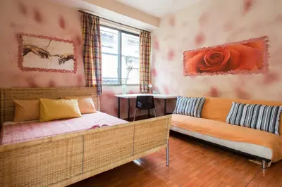 a bedroom with a bed and a couch and a table at WineSpa Oasis in Athens ! in Athens