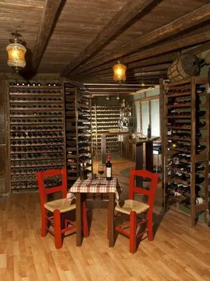 a dining room with a table and chairs and wine racks at WineSpa Oasis in Athens ! in Athens