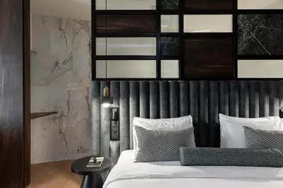 a bedroom with a bed with a black headboard at The Stanley in Athens