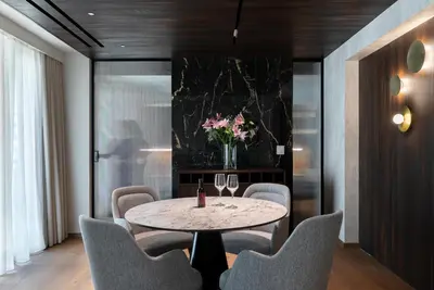 a dining room with a table and chairs and a vase of flowers at The Stanley in Athens