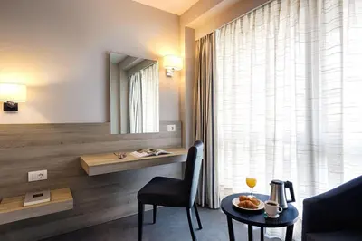 a living room with a table and a mirror at The Stanley in Athens