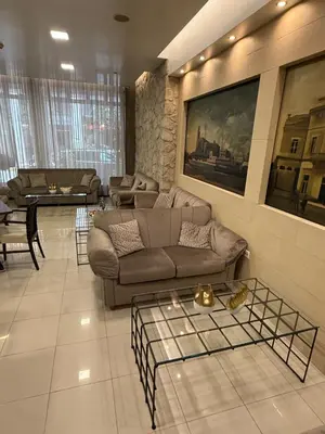 a living room with a couch and a table at Hotel Ideal in Piraeus