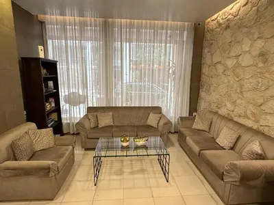 a living room with two couches and a table at Hotel Ideal in Piraeus
