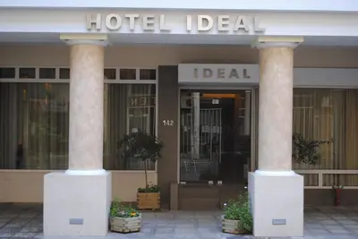 a hotel with two columns in front of a building at Hotel Ideal in Piraeus