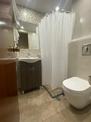 a bathroom with a toilet and a sink at Hotel Ideal in Piraeus