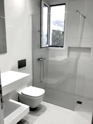 a white bathroom with a shower and a toilet at ATHENS RIVIERA Grand Panoramic Villa II Lagonissi in Lagonissi