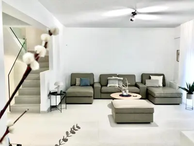 a living room with a couch and a table at ATHENS RIVIERA Grand Panoramic Villa II Lagonissi in Lagonissi