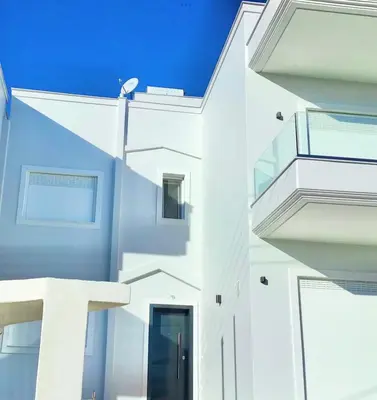 a white building with a blue sky in the background at ATHENS RIVIERA Grand Panoramic Villa II Lagonissi in Lagonissi