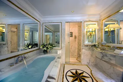 a large bathroom with a tub and a sink at Royal Olympic Hotel in Athens
