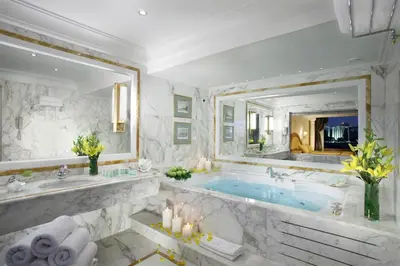 a bathroom with a tub and a large mirror at Royal Olympic Hotel in Athens