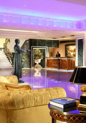 a living room with a statue of a woman on a couch at Royal Olympic Hotel in Athens