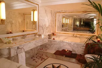 a bathroom with a tub and a large mirror at Royal Olympic Hotel in Athens