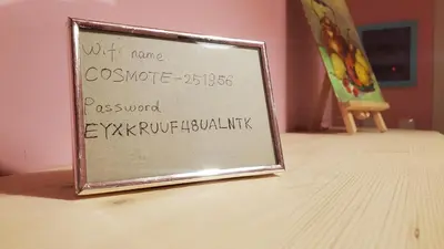 a sign sitting on top of a table at Sakura Hut opposite the Panathenaic Stadium in Athens