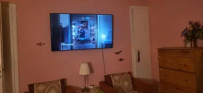a flat screen tv hanging on a wall at Sakura Hut opposite the Panathenaic Stadium in Athens
