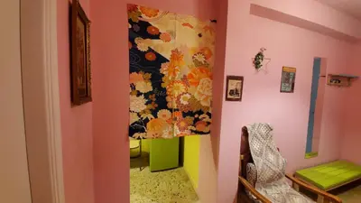 a room with pink walls and a colorful wall at Sakura Hut opposite the Panathenaic Stadium in Athens