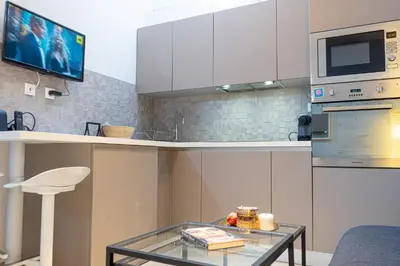 a kitchen with a glass table and a microwave at Nikkis Flat - Kolonaki Square in Athens