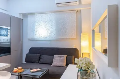 a living room with a couch and a table at Nikkis Flat - Kolonaki Square in Athens