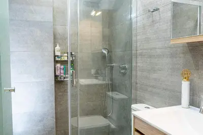 a bathroom with a shower and a toilet and a sink at Nikkis Flat - Kolonaki Square in Athens