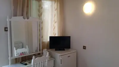 a room with a tv on top of a dresser at Rachel Hotel in Agia Marina Aegina