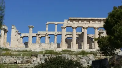 an ancient building with columns in front at Rachel Hotel in Agia Marina Aegina