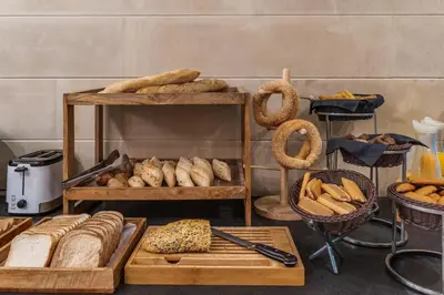 a bunch of breads and other food items on display at Athenaeum Eridanus Luxury Hotel in Athens