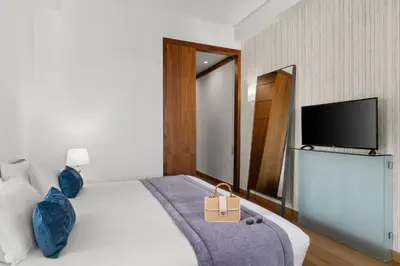 a hotel room with a bed and a flat screen tv at Athenaeum Eridanus Luxury Hotel in Athens