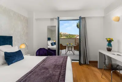 a hotel room with a bed and a balcony at Athenaeum Eridanus Luxury Hotel in Athens