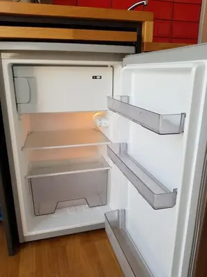 an empty refrigerator with its door open in a kitchen at The Terrace with Acropolis & Athens view in Athens