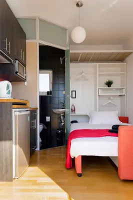 a bedroom with a bed with a red blanket at The Terrace with Acropolis & Athens view in Athens