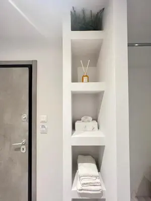 a bathroom with white shelves and a sink at JV Athens in Athens