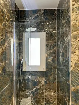 a bathroom with a window and a shower at JV Athens in Athens