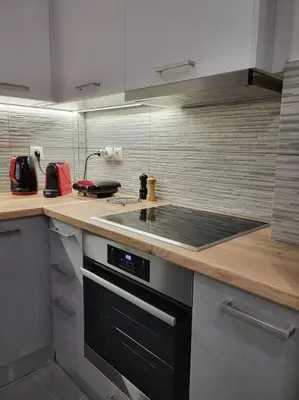 a kitchen with a counter with a stove top oven at Plaka Sofi Suite in Athens