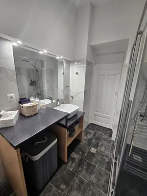a bathroom with a sink and a mirror at Plaka Sofi Suite in Athens
