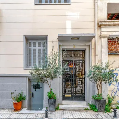 a door to a building with trees in front of it at Plaka Sofi Suite in Athens