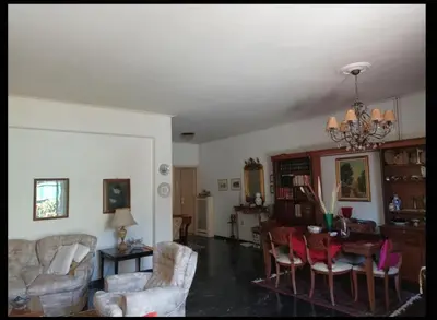 a living room with a chandelier and a table and chairs at Spacious Double room in the Center of Athens in Athens