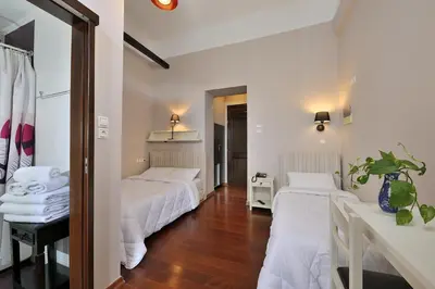 a hotel room with two beds and a mirror at Dryades & Orion Hotel in Athens