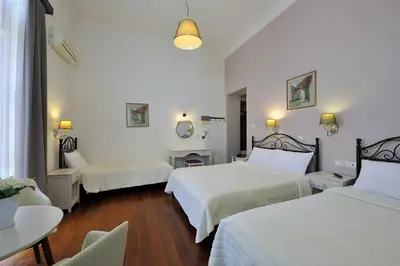 a hotel room with two beds and a table at Dryades & Orion Hotel in Athens