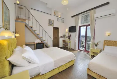 a hotel room with two beds and a staircase at Dryades & Orion Hotel in Athens