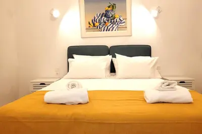 a bedroom with a large bed with towels on it at Acropolis Thisio Apartment 2 bedrooms 2 bathrooms in Athens