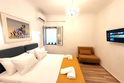 a small room with a bed and a chair at Acropolis Thisio Apartment 2 bedrooms 2 bathrooms in Athens