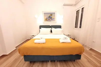 a bedroom with a large bed with two towels on it at Acropolis Thisio Apartment 2 bedrooms 2 bathrooms in Athens