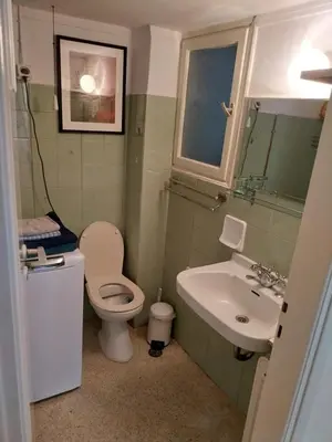 a bathroom with a toilet and a sink at Park-view apartment in Athens