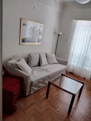 a living room with a couch and a coffee table at Park-view apartment in Athens
