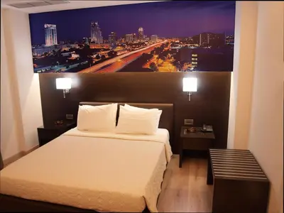 a bedroom with a bed with a large painting on the wall at Athens City Hotel in Athens