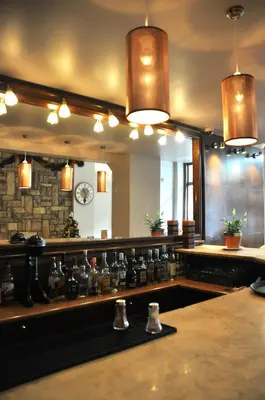 a kitchen with a counter with a large mirror at Athens City Hotel in Athens