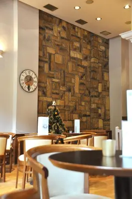 a christmas tree on a wall in a restaurant at Athens City Hotel in Athens