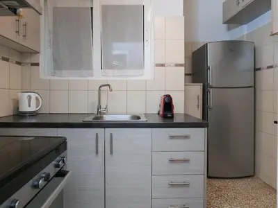a kitchen with a refrigerator and a sink at Alluring 2BR apartment in Thiseio in Athens