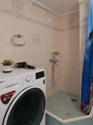 a washing machine in a bathroom with a shower at Alluring 2BR apartment in Thiseio in Athens